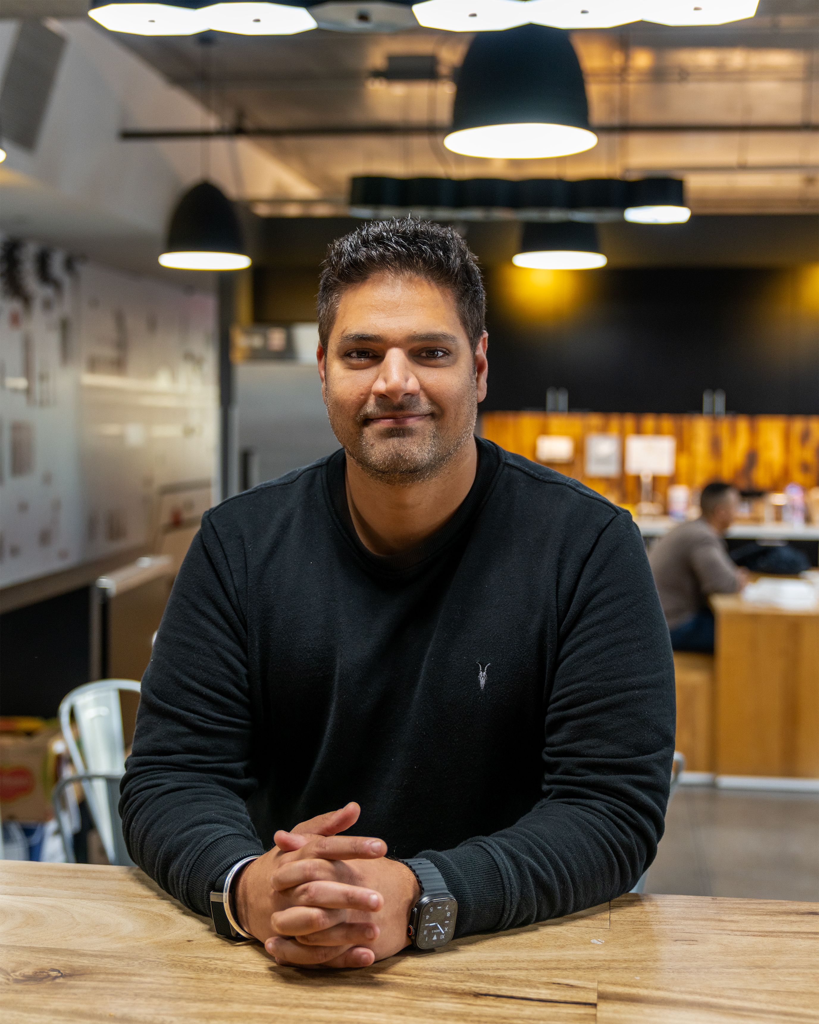 Portrait of Siddharth Astir seated in a workspace